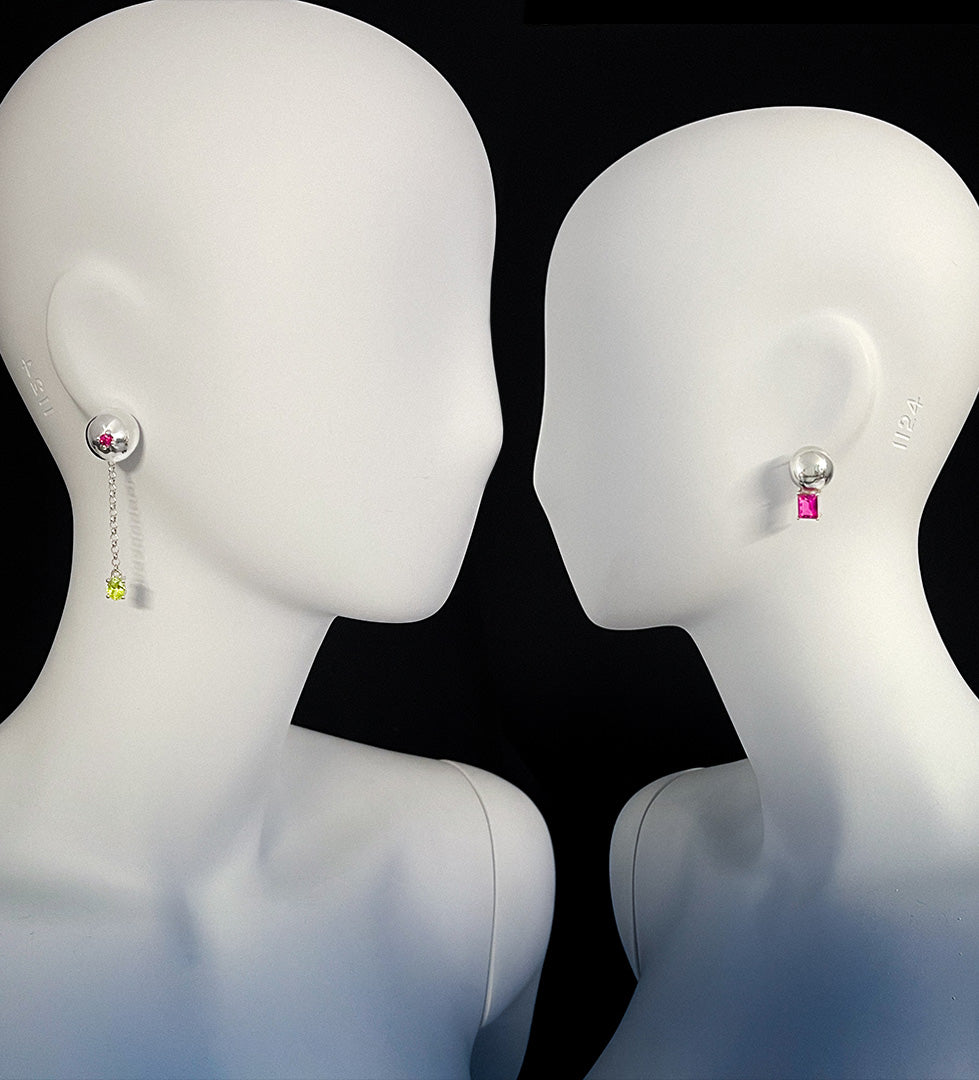 monumental statement sphere Earrings on a mannequin with a black background