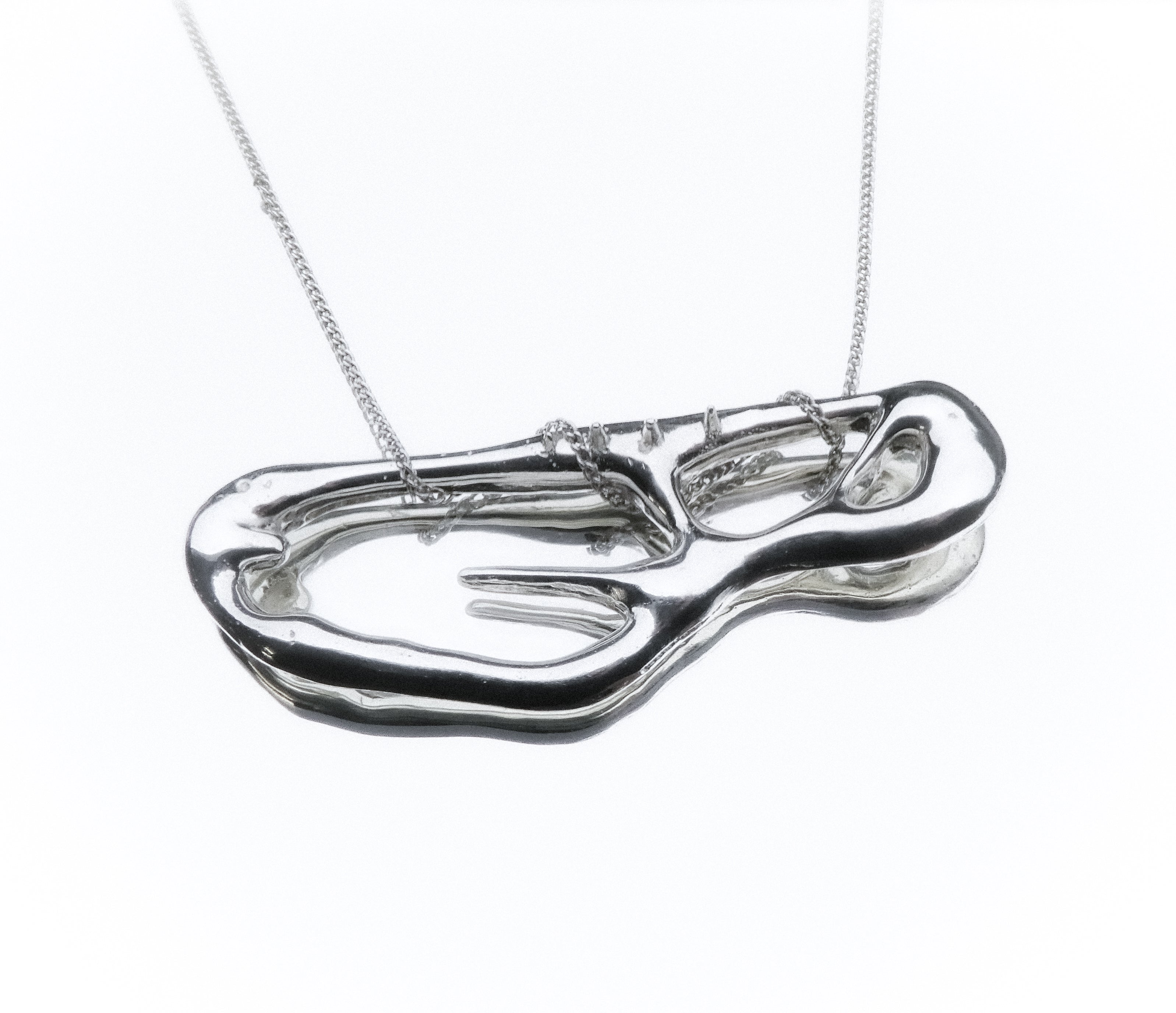 Silver necklace with a unique pendant on a white background monumental liquid shape