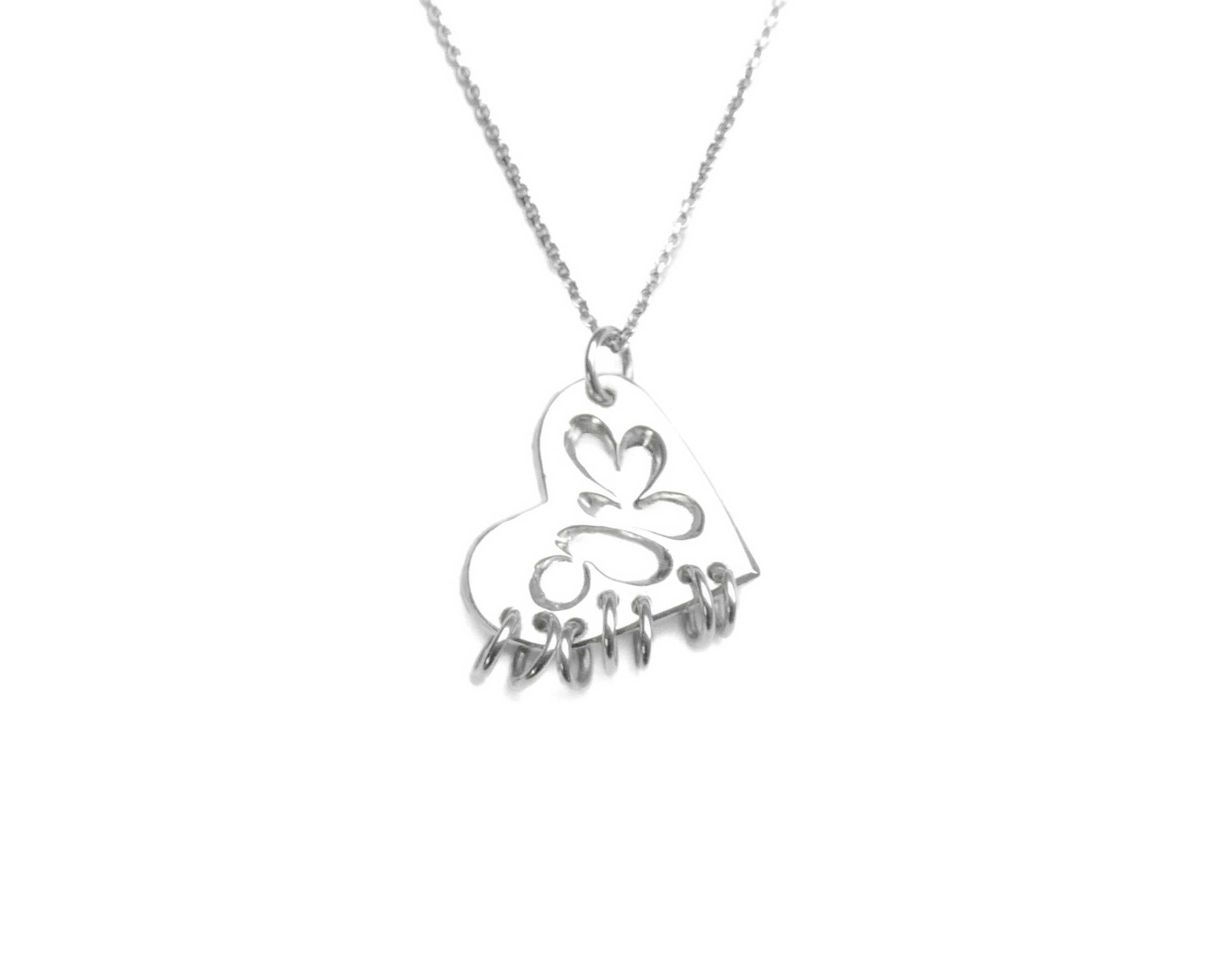 Silver necklace with a heart-shaped pendant on a white background